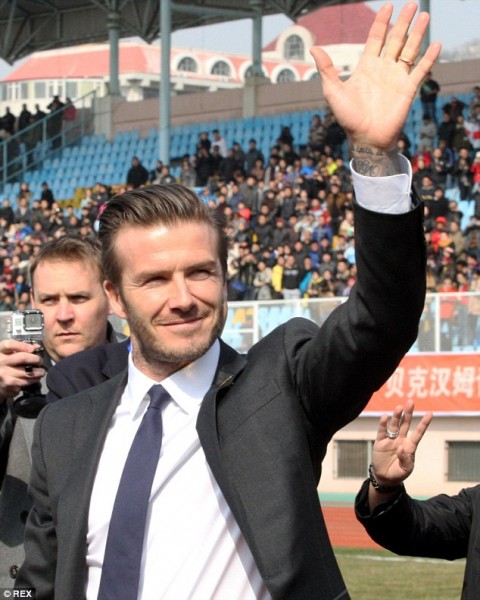 David Beckham waves to a crowd in China