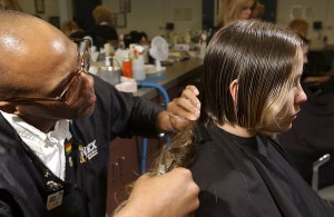 Long hair being cut by a barber