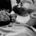 Man having his beard shaved