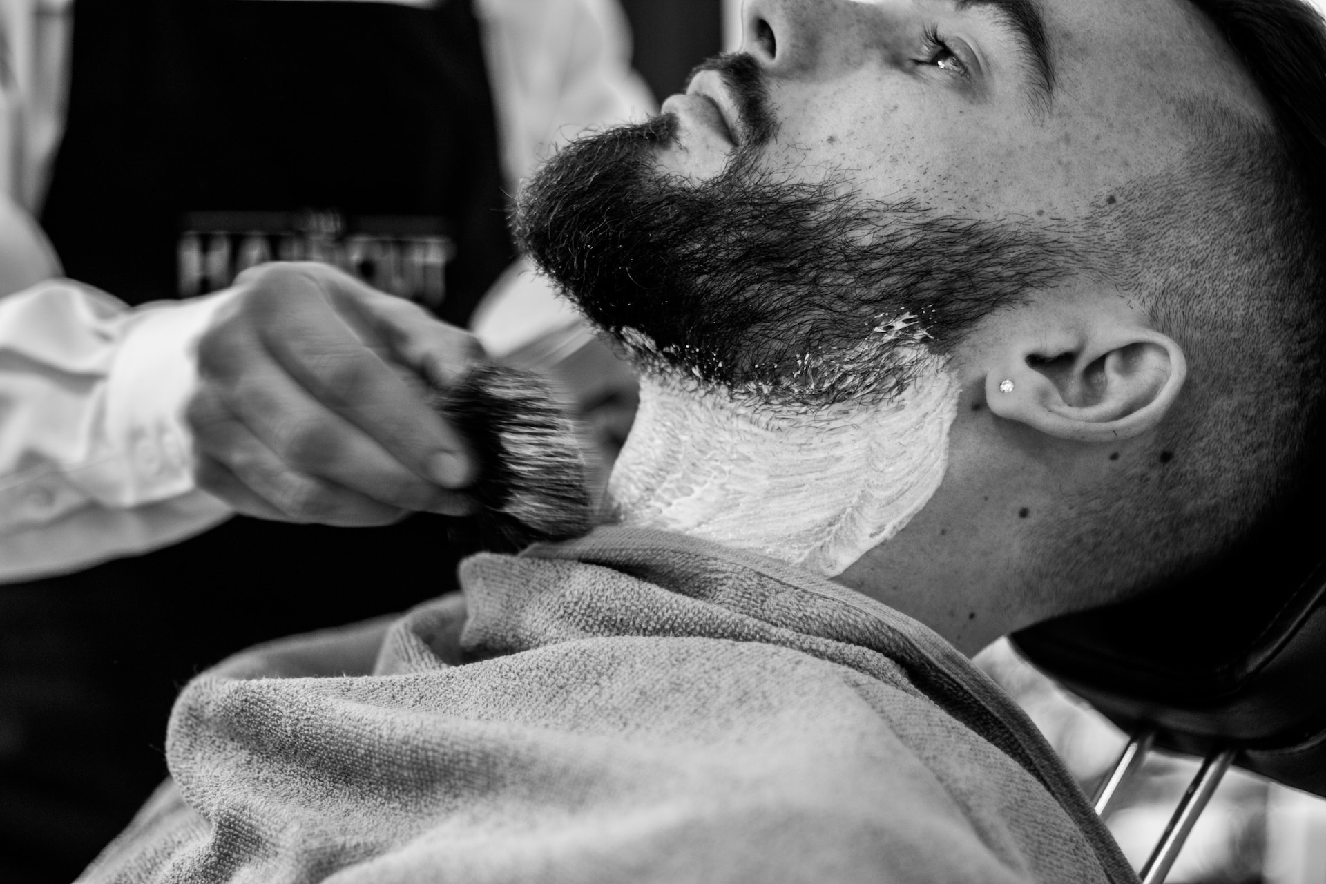 Man having his beard shaved